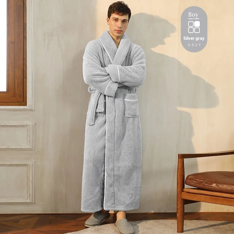 A man and woman wearing matching navy blue thick flannel bathrobes, showcasing the wrap-around design and plush fabric.