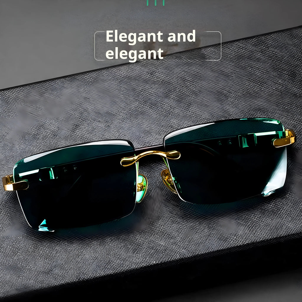 Frameless dark green crystal lens sunglasses with adjustable nose pads on a table next to their hard case.