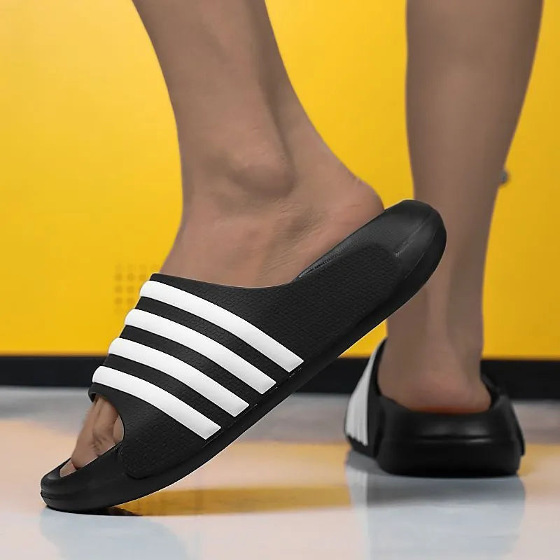 A pair of beige unisex casual sliders with a PVC upper and textured EVA sole.