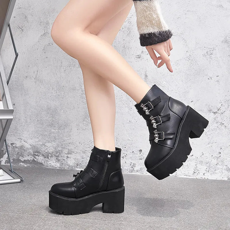 Black women's punk gothic ankle boots with a bat buckle and side zipper on a thick sole.