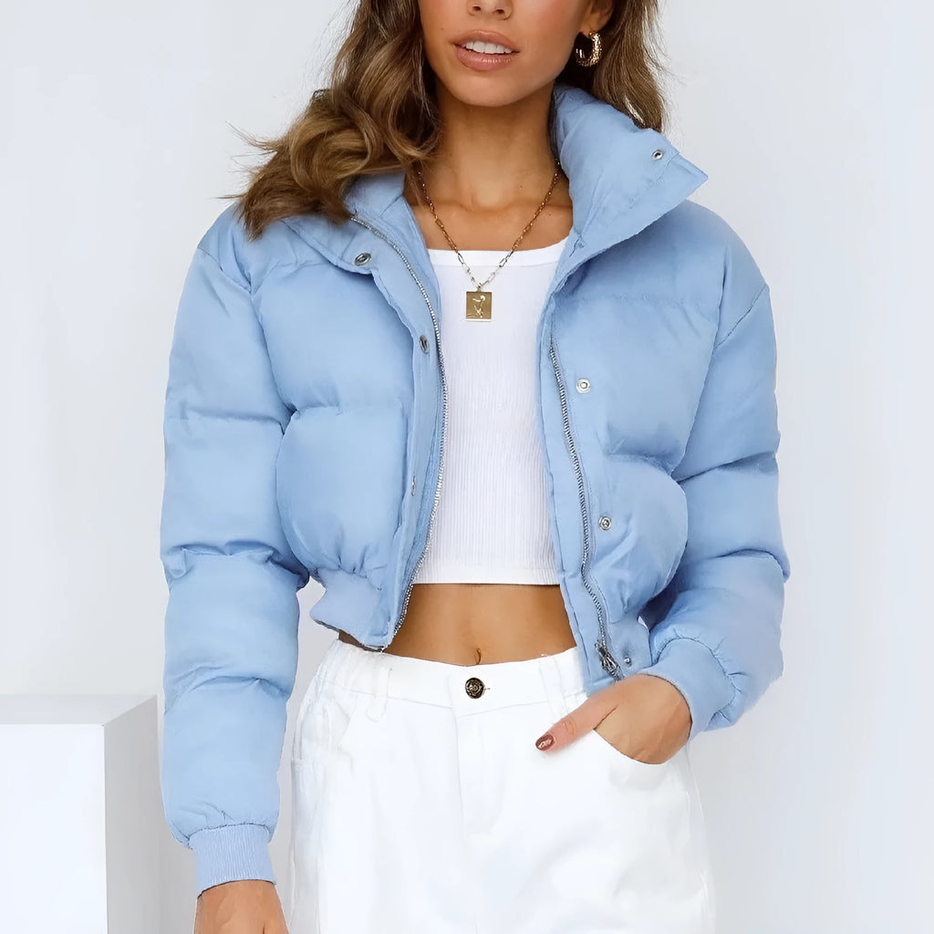 A woman's loose-fitting blue polyester casual jacket with long sleeves on a hanger.