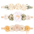 Three cloth flower-shaped hair bands for children in different styles on a light background