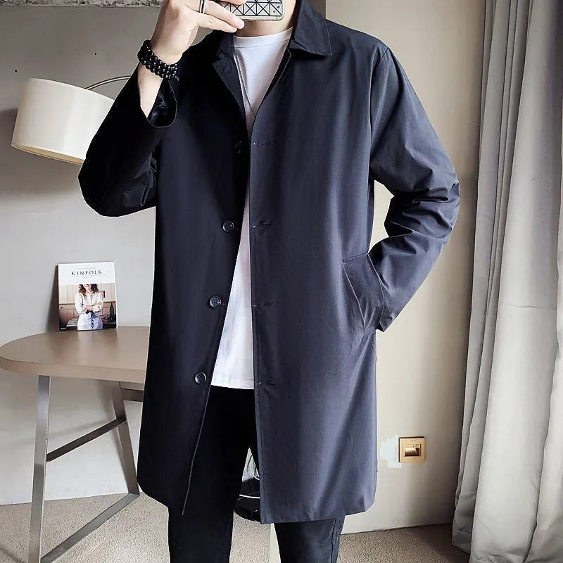 Man wearing a khaki-coloured, loose-fit mid-length trench coat made of rabbit fur.