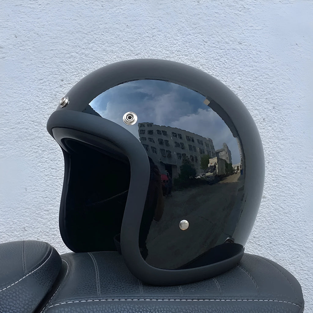 Retro-style motorcycle half helmet in cement grey with a glossy fibreglass shell on a plain background.