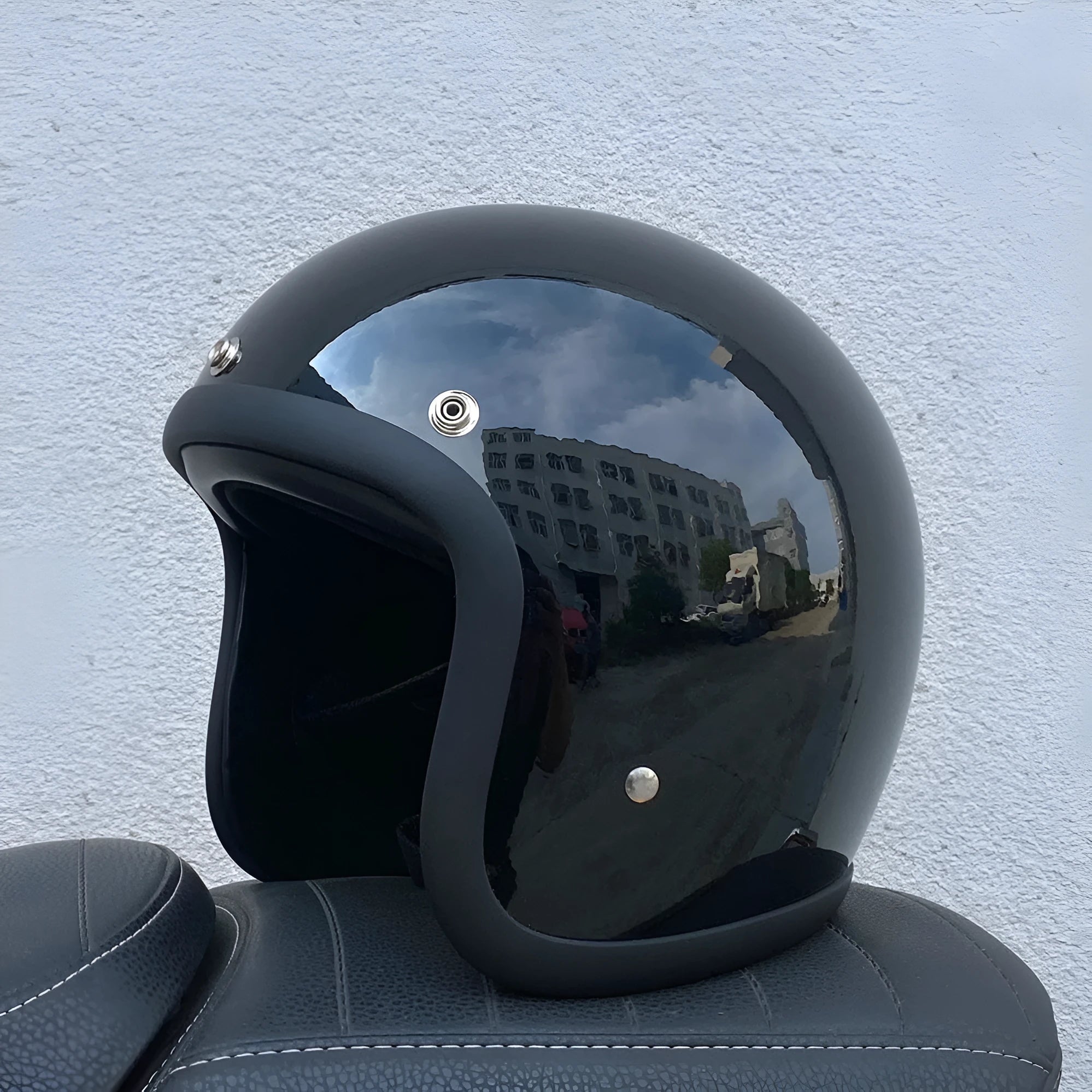 Retro-style motorcycle half helmet in cement grey with a glossy fibreglass shell on a plain background.