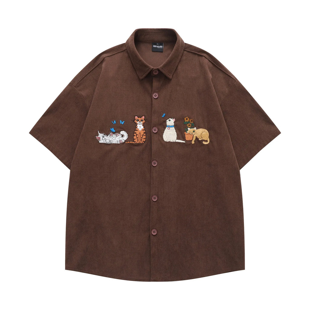Loose fit cardigan shirt with cartoon embroidery in apricot colour, showing front design.