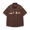 Loose fit cardigan shirt with cartoon embroidery in apricot colour, showing front design.
