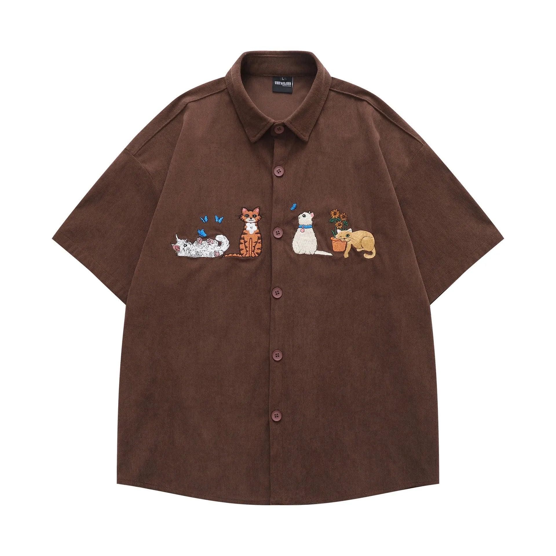 Loose fit cardigan shirt with cartoon embroidery in apricot colour, showing front design.