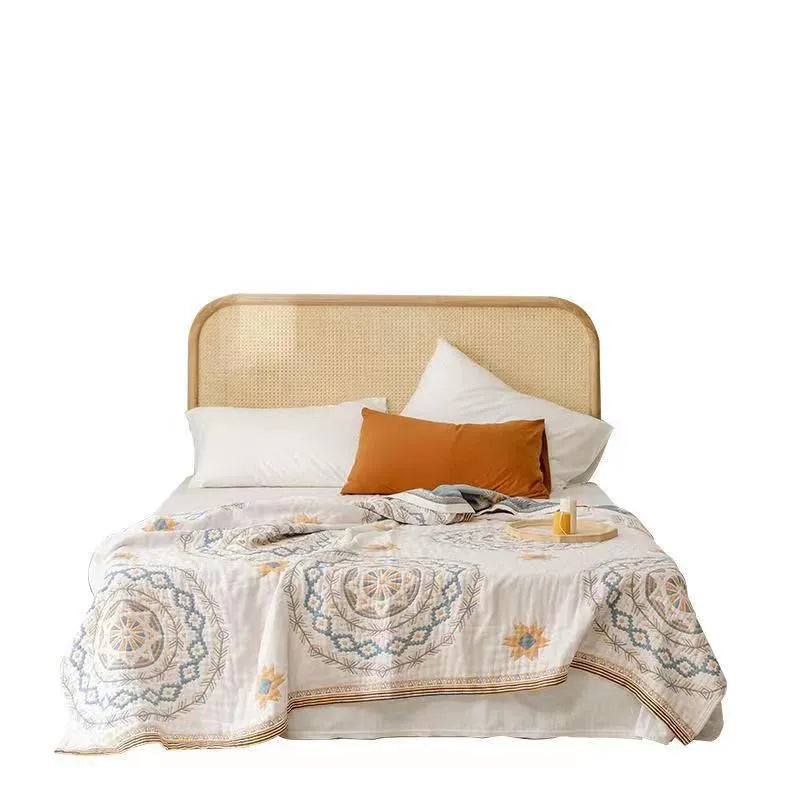 Geometric pattern cotton towel blanket laid flat, showing its textured weave and rectangular shape.