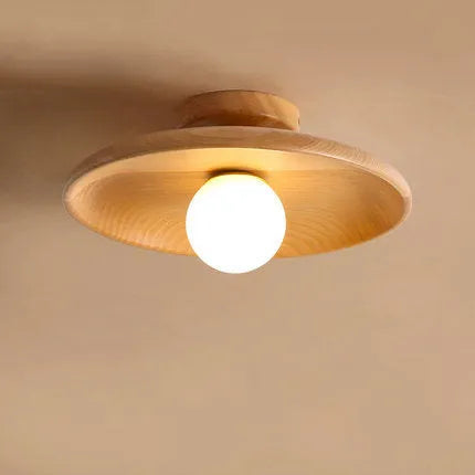 Modern minimalist solid wood and glass ceiling lamp in a hallway setting.