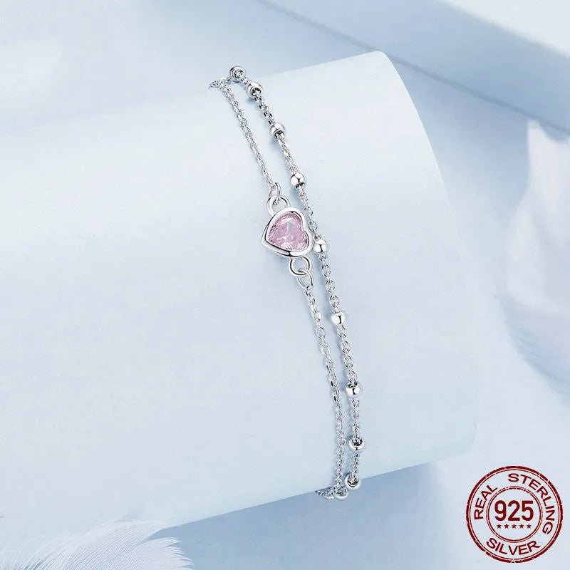 Women's sweet style sterling silver bracelet with small heart pendant on an adjustable chain.