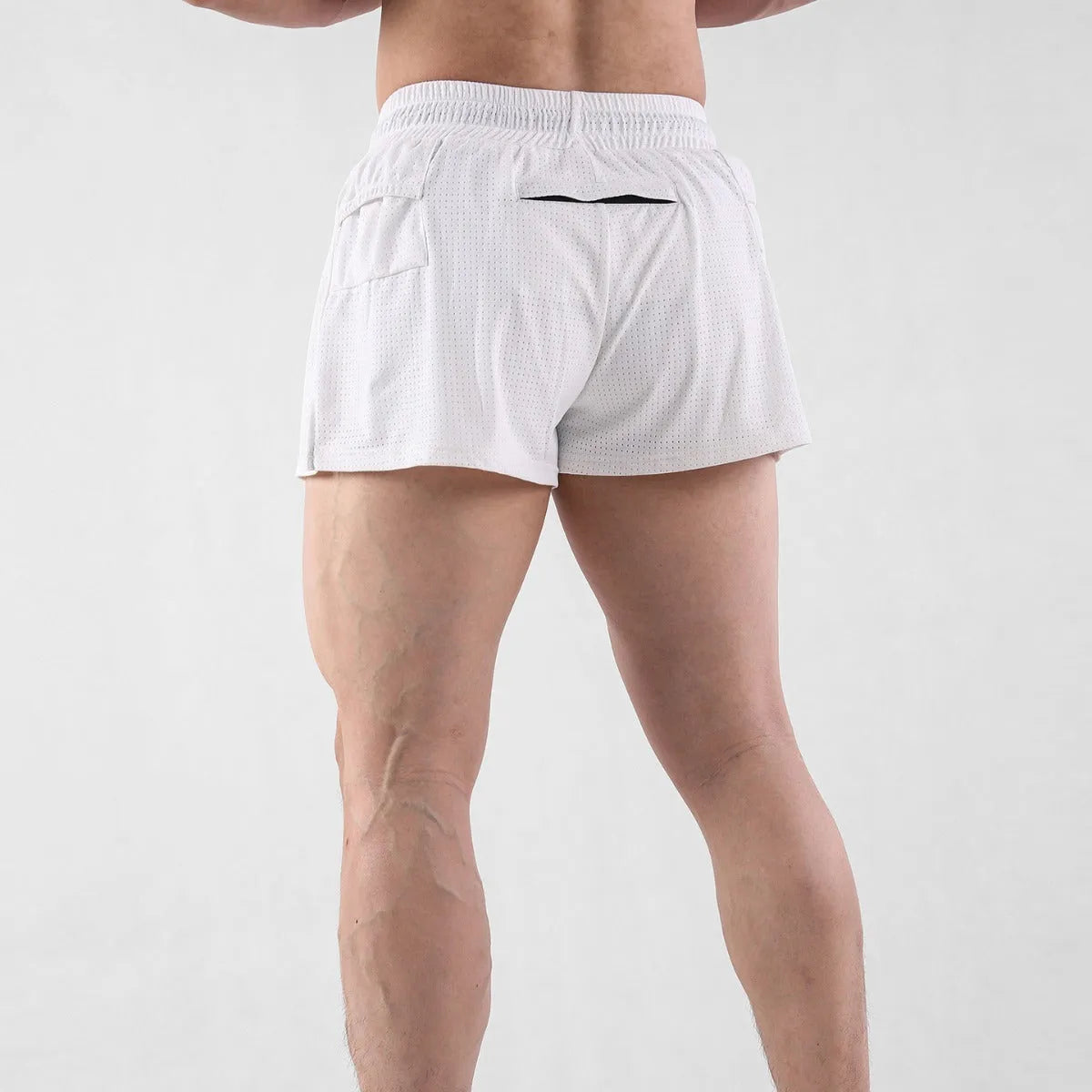 Man wearing black quick-drying nylon summer shorts with a mid-waist fit