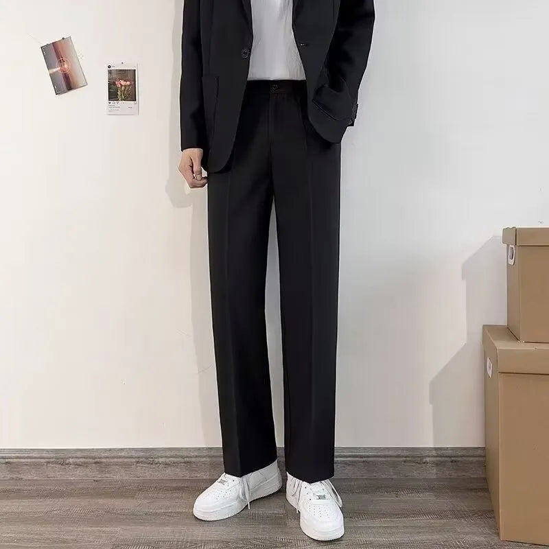Plus size men's loose fit college style suit set with trousers, white shirt, and tie on a hanger.