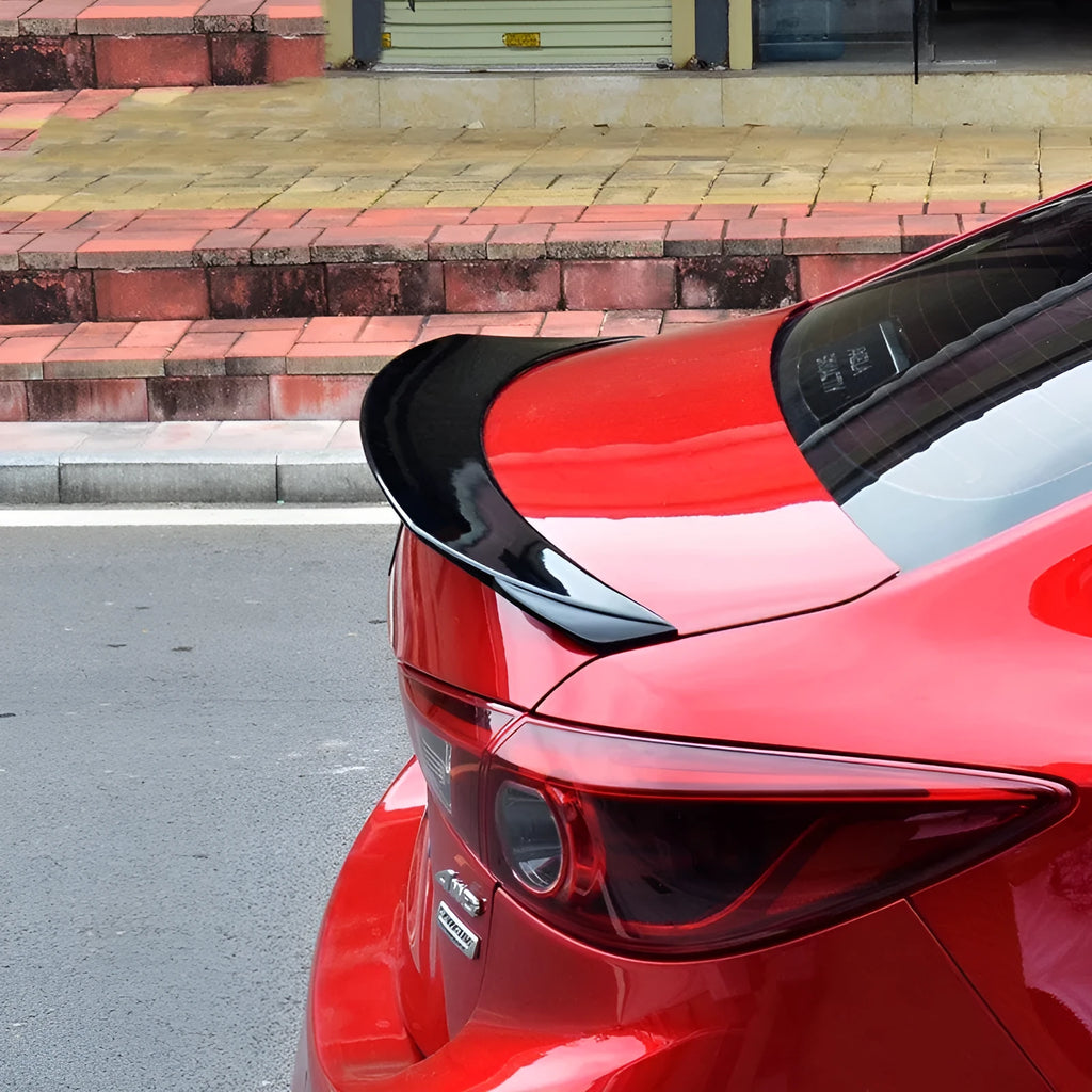 Large bright black fixed rear spoiler wing for Mazda 3 Axela Exela on car boot.