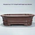 Handmade purple sand rectangular antique begonia flower pot on a desktop.