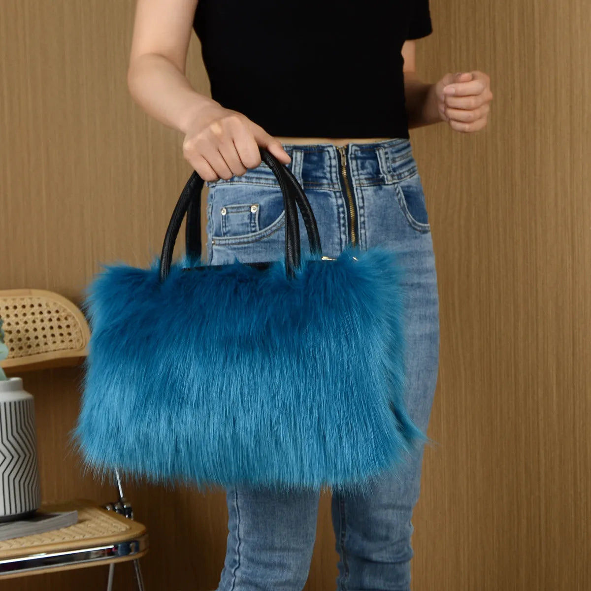 Hand-carrying square plush bag in pink with soft faux fur exterior and horizontal shape