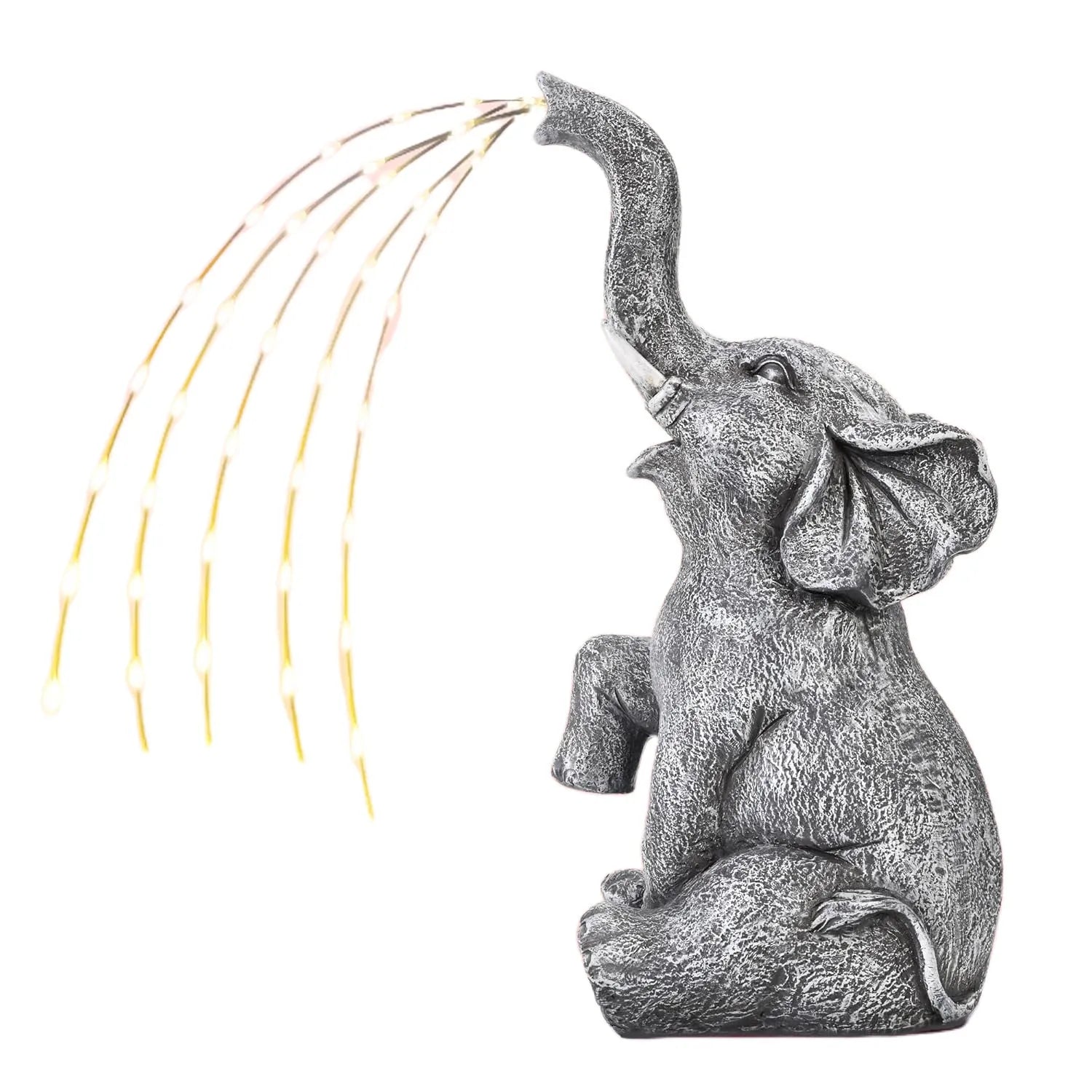 A textured resin elephant garden statue with a built-in LED light strip illuminating its back, placed amongst plants.