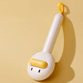 Small yellow duck-shaped pet grooming comb with open sections and needle bristles