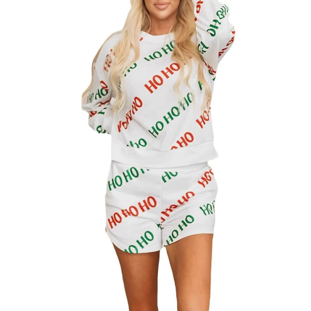White women's two-piece street fashion suit with letters print on the long-sleeved top and matching trousers.