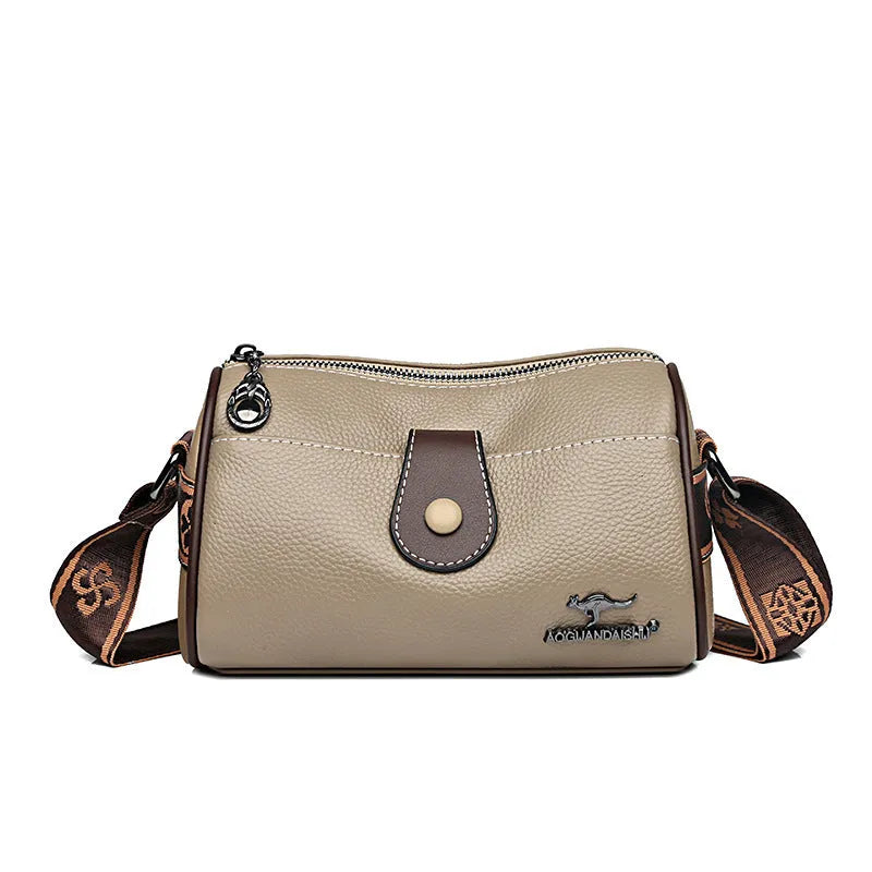 Women's top grain leather crossbody bag in blue, black, or khaki with horizontal square shape and inner pockets.