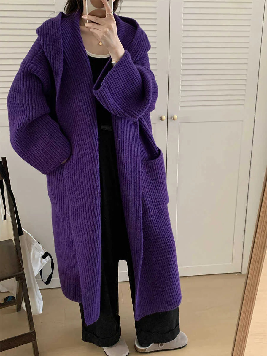 Women's loose grey hooded cardigan coat with raglan sleeves on a hanger.