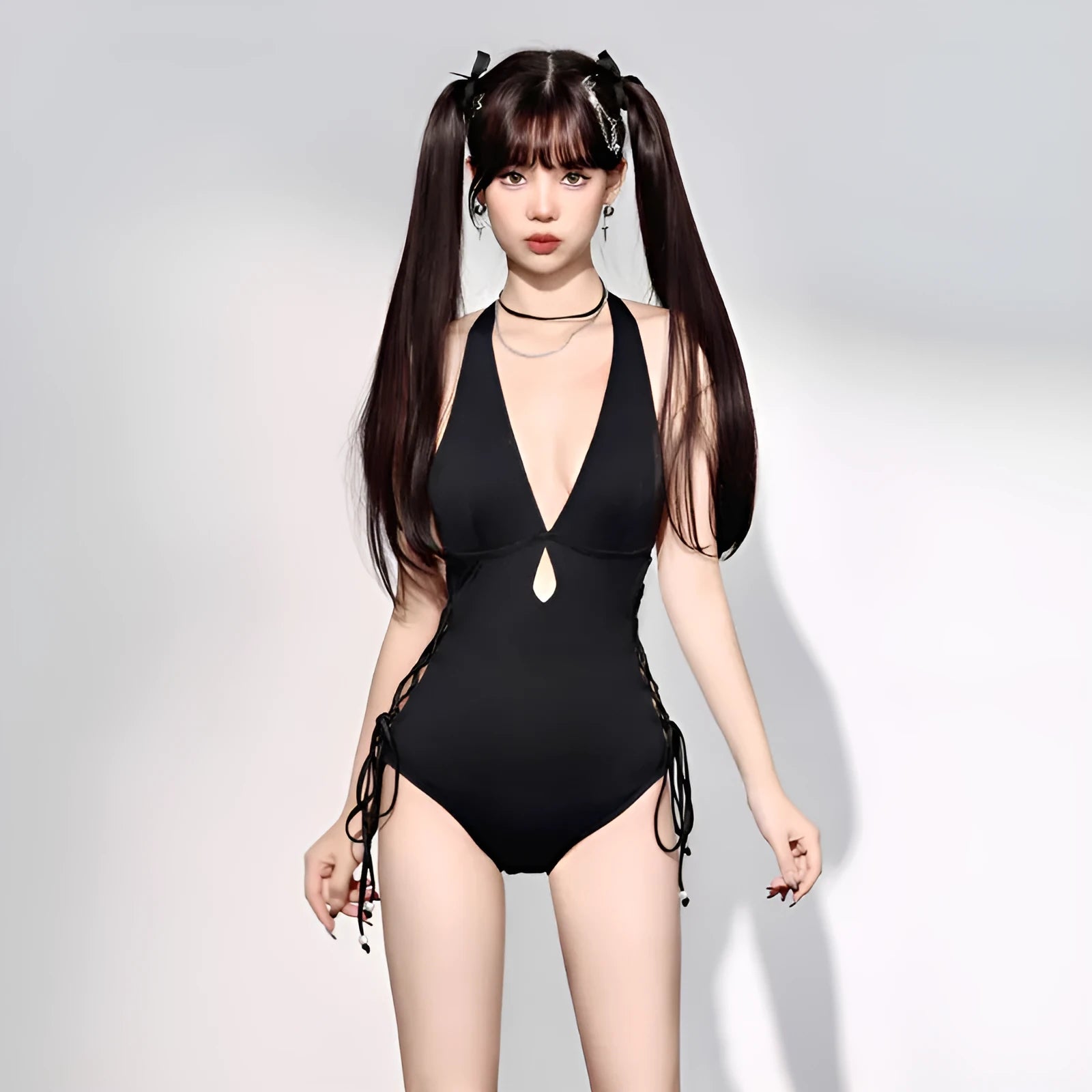 Black women's one-piece swimsuit with V-neck and hollow strap detail.