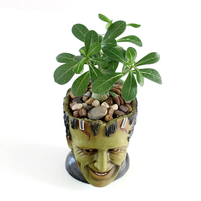 Green personalized resin flower pot with Frankenstein container design and drainage holes for desktop plant display