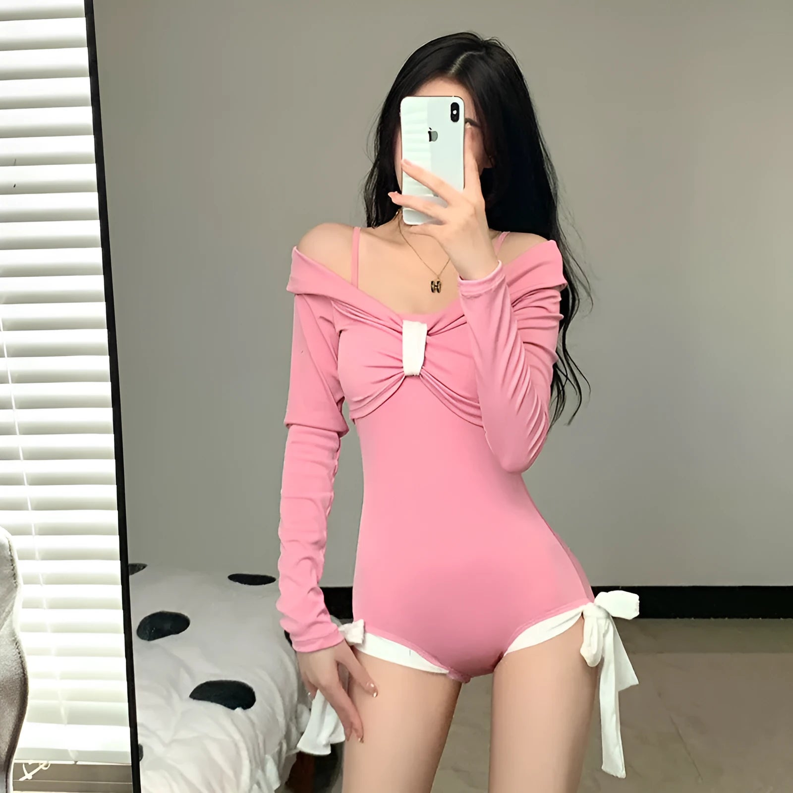 Women's long sleeve one-piece swimsuit in black or pink with figure-flattering design