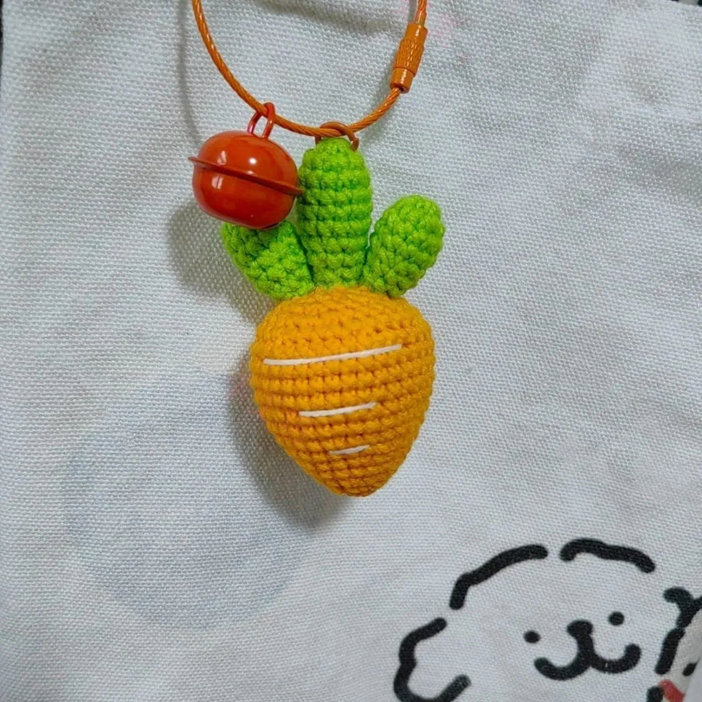 Soft wool keychain pendant shaped like a cartoon carrot car on a keyring.
