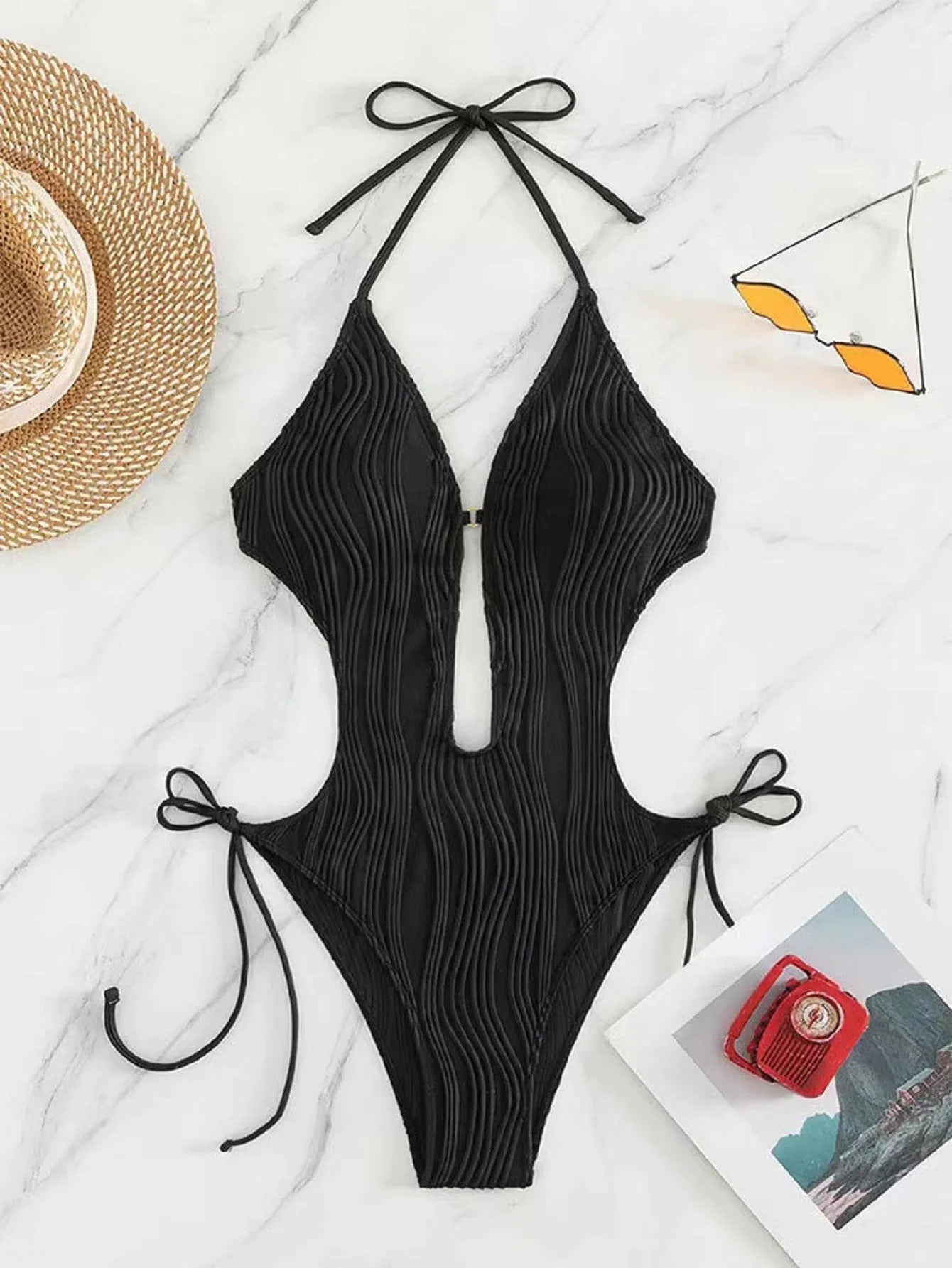 Women's black lace-up triangle bikini swimsuit with adjustable front detailing on mannequin