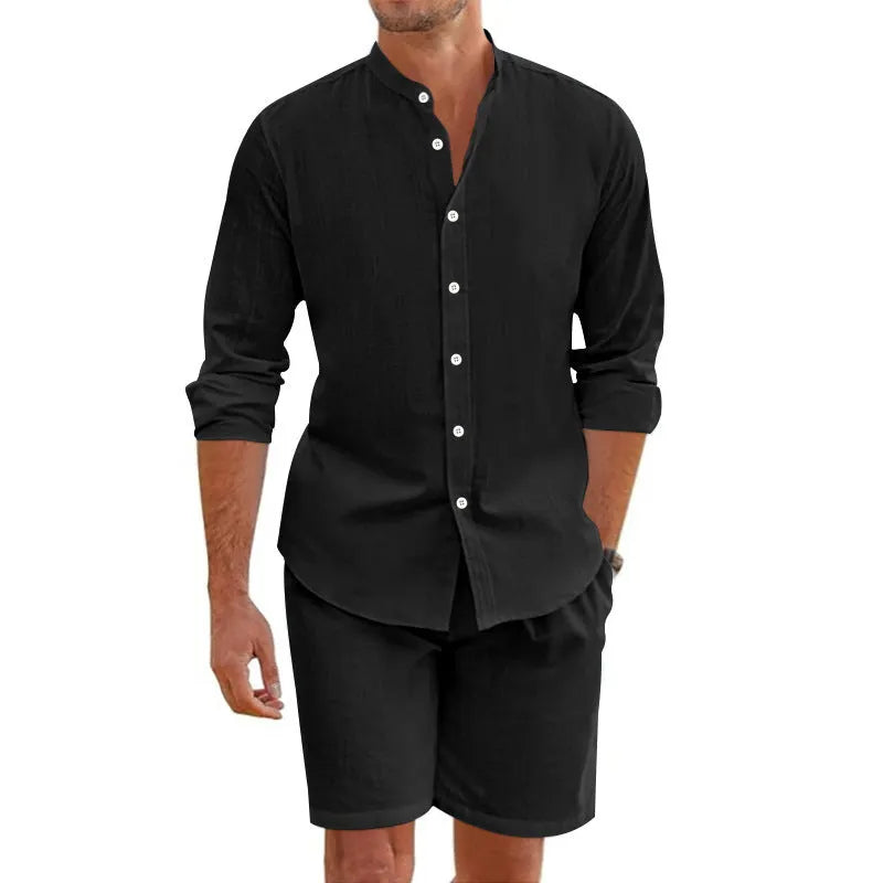 Men's dark grey linen-blend short sleeve button-down shirt and matching drawstring shorts on a beach
