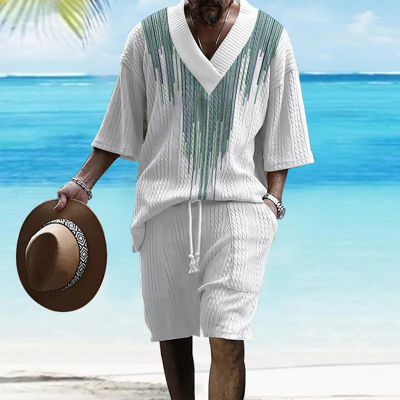 Man wearing a printed drop-shoulder knitted short-sleeve top and matching shorts in a casual setting.