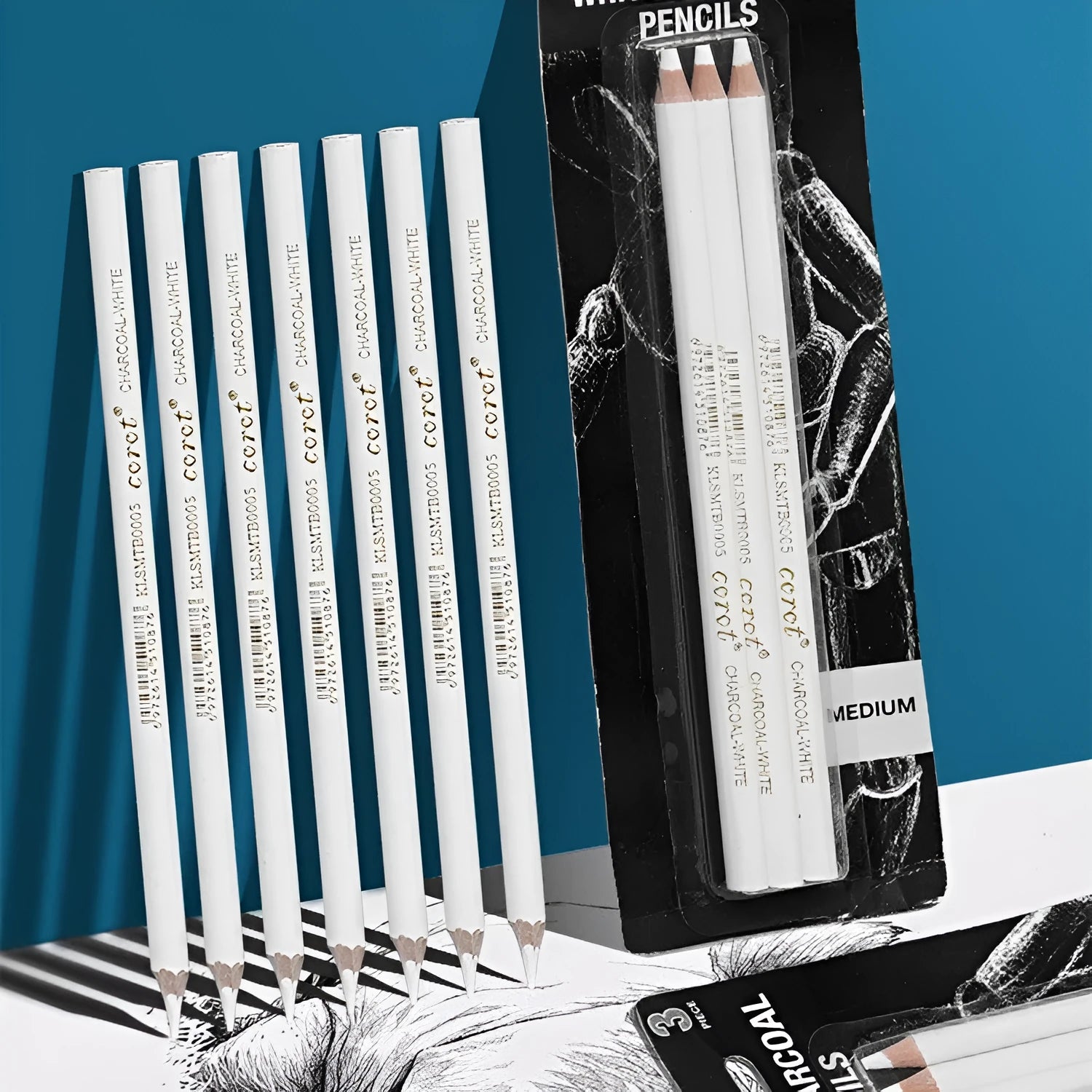 Set of three white charcoal pencils with wooden barrels for sketching on dark paper.