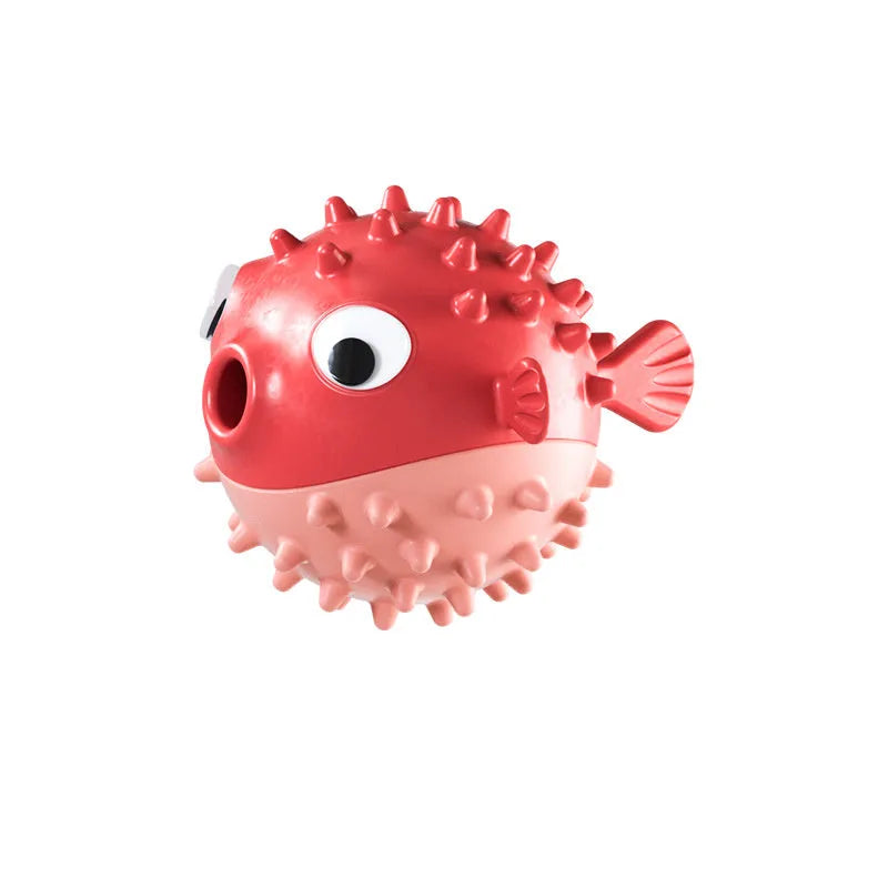 Green fish-shaped interactive dog toy with treat dispensing opening and textured surface for dental cleaning