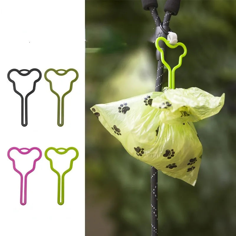 A hands-free dog poop bag holder with a hook and loop fastener strap, shown attached to a dog leash.
