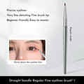 Close-up of a bent head eyeliner brush with a 45-degree angle and flat synthetic bristles for detail makeup.