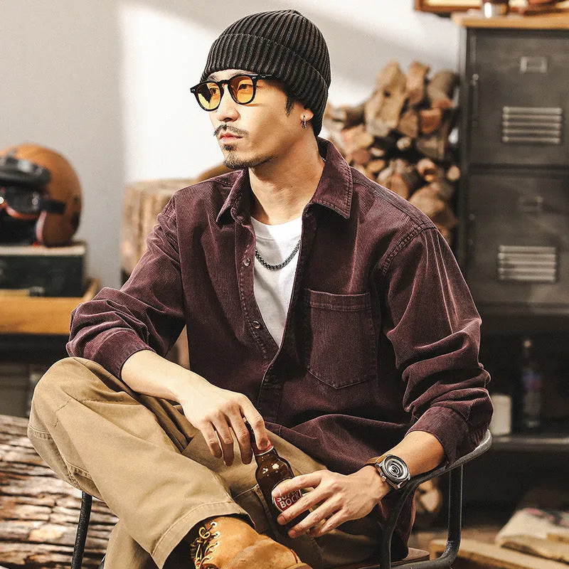 A man's loose-fit retro corduroy shirt jacket in red, featuring long sleeves and a button-front design.