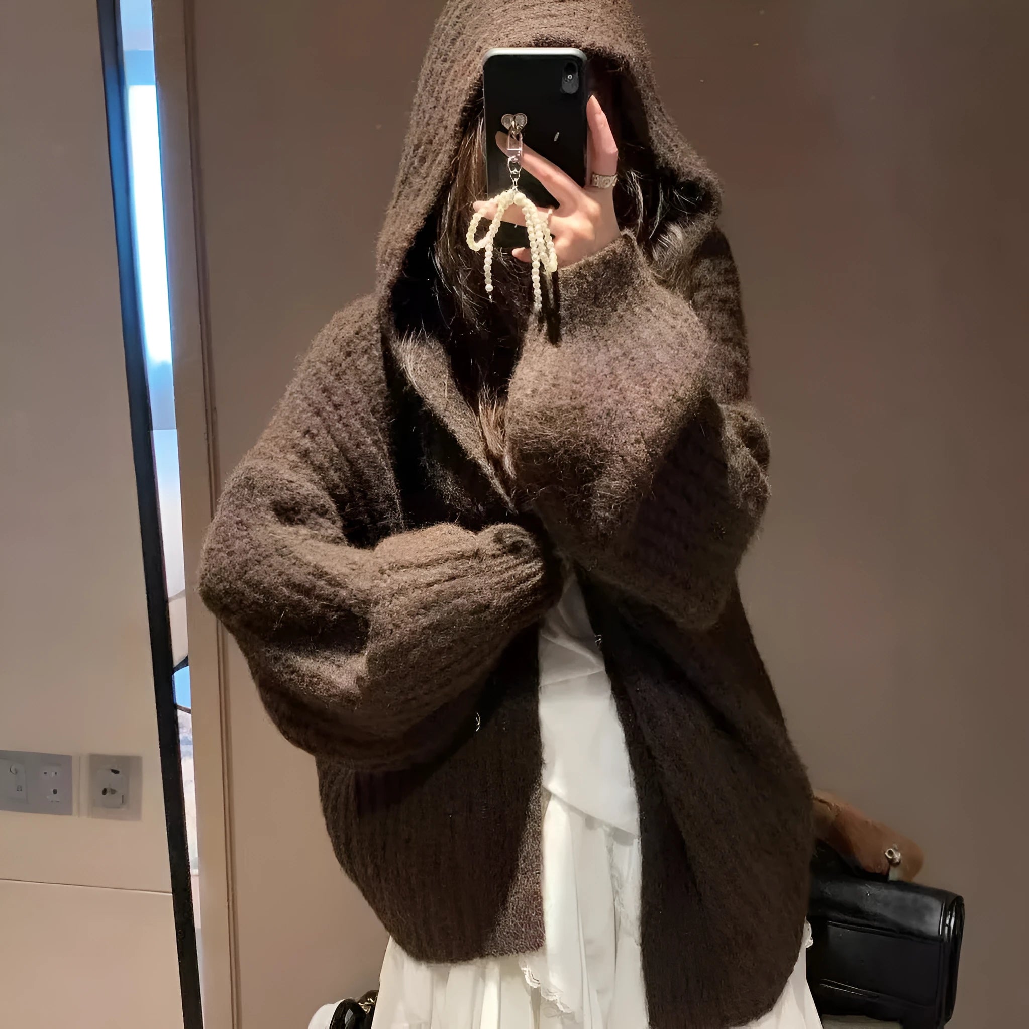 Women's brown retro-style hooded cardigan with a thick knit texture on a hanger.