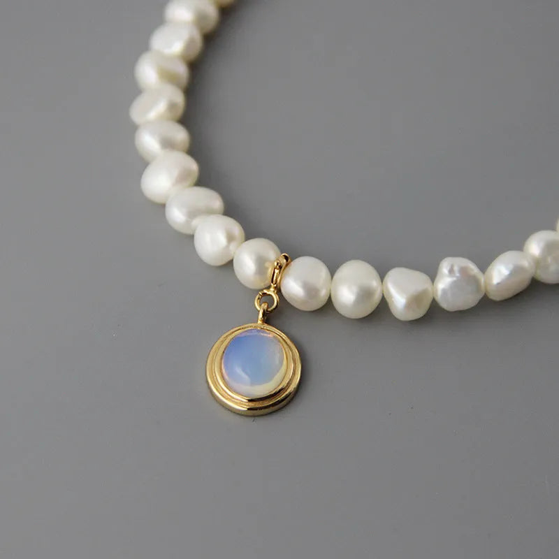 Silver necklace with round medal and irregular pearl geometric pendant on adjustable chain