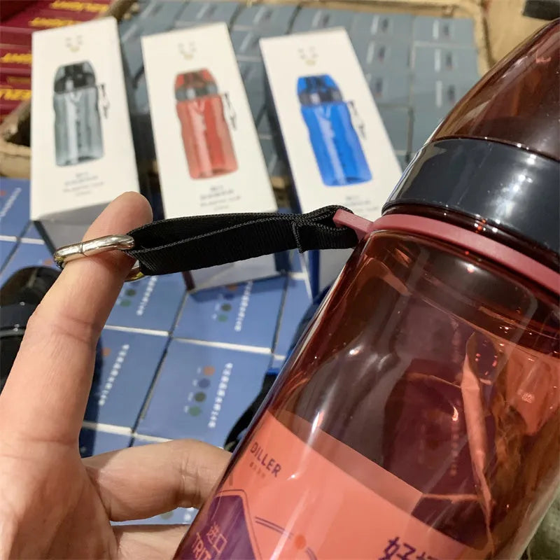 Chinese-style blue portable sports water bottle with integrated tea compartment and removable filter on a grey background.