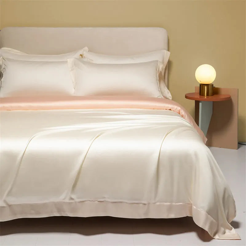 A modern, neatly made bed with a Lenzing Tencel duvet cover and pillowcases in a choice of nine colours like Sea Salt Blue.