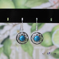 Handmade Miao silver and turquoise flower disk earrings with auspicious cloud pattern in blue.