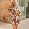 Orange striped floral print mini dress with long sleeves, V-neck, and lace detailing.