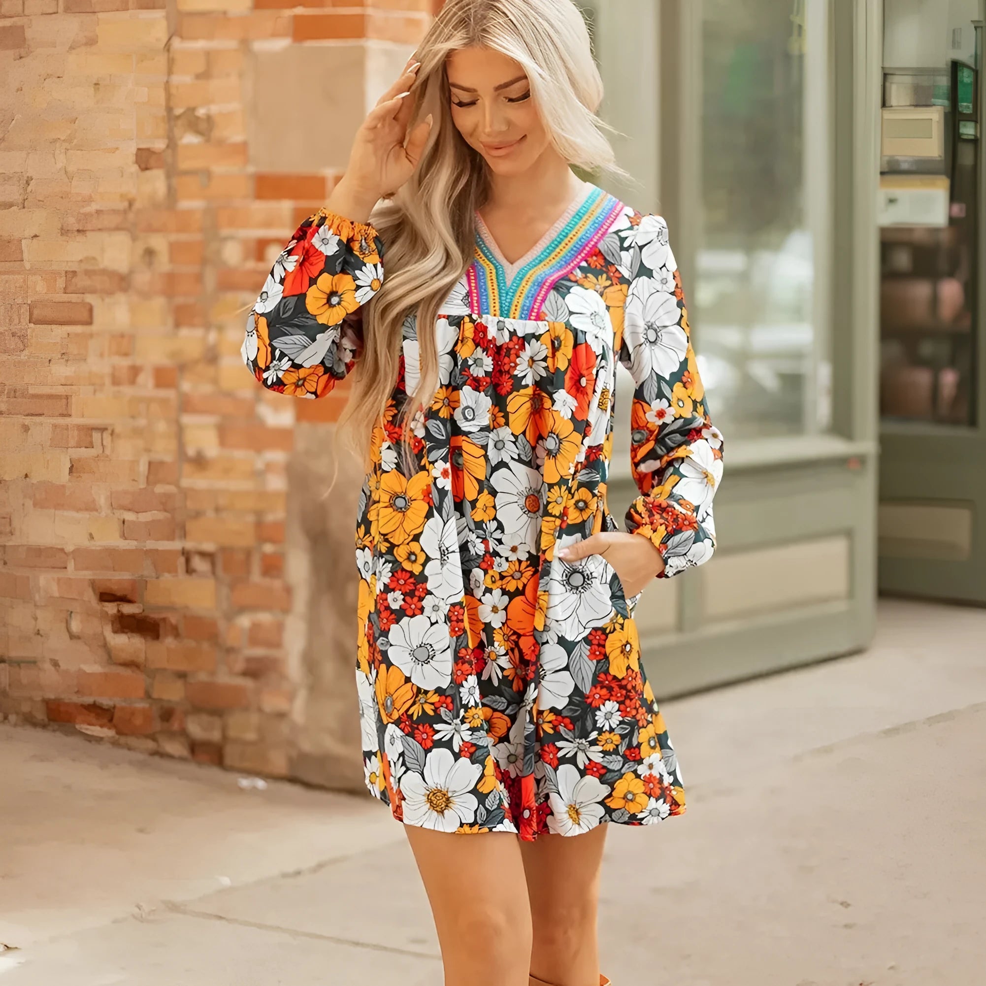 Orange striped floral print mini dress with long sleeves, V-neck, and lace detailing.