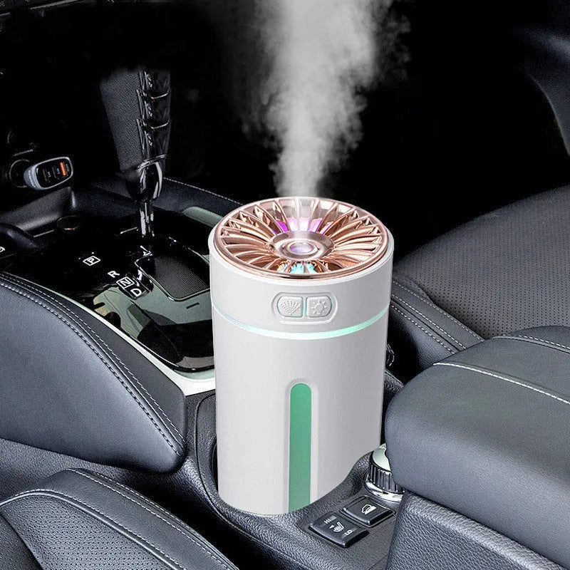 Black portable USB rechargeable humidifier with colourful lights on a car cup holder.