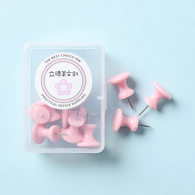 Plastic push pins in cherry blossom pink, mint green, and lavender, showing large and small sizes on a corkboard