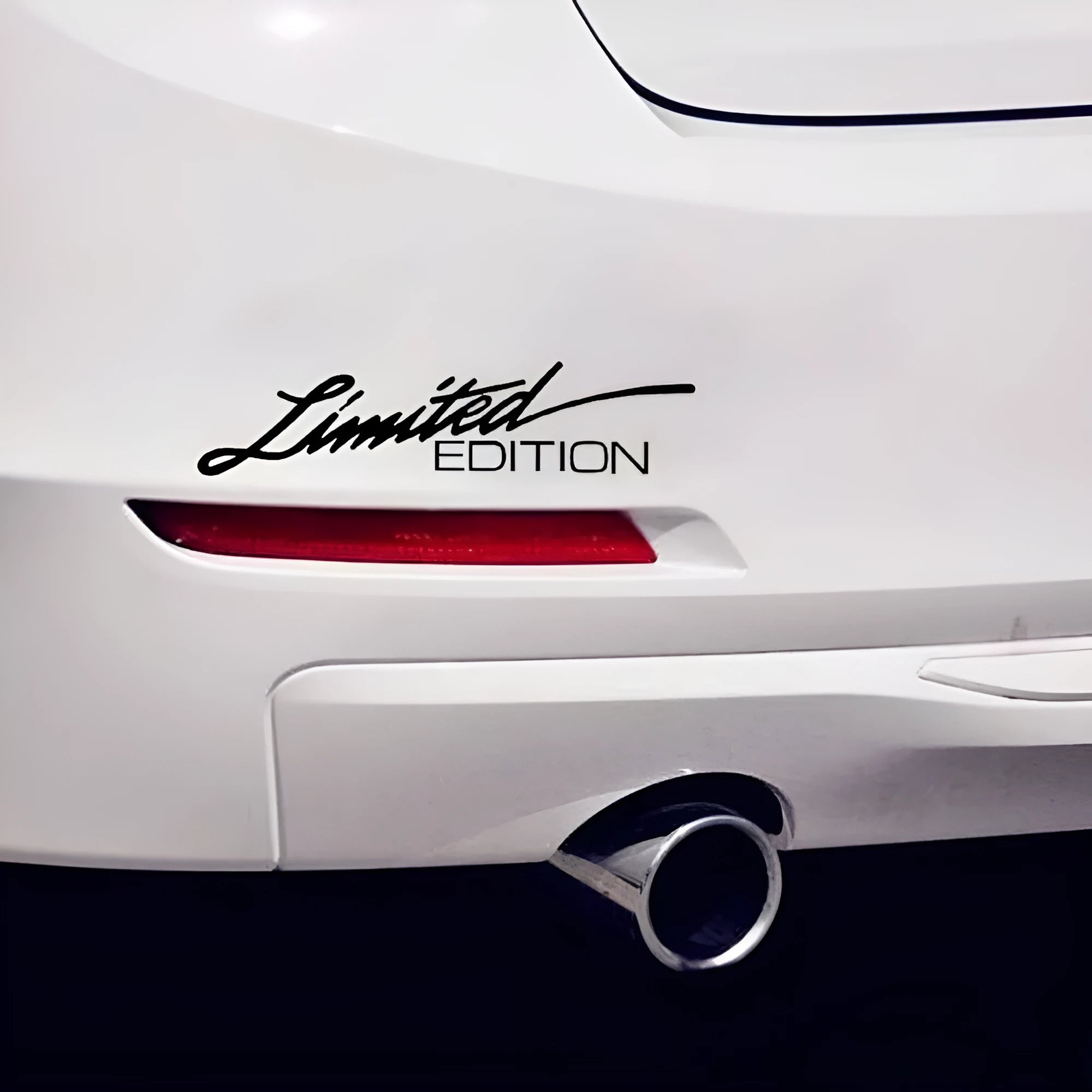 A black, white, and colourful British style reflective plastic bumper sticker, shown at its 16cm by 3.8cm size.