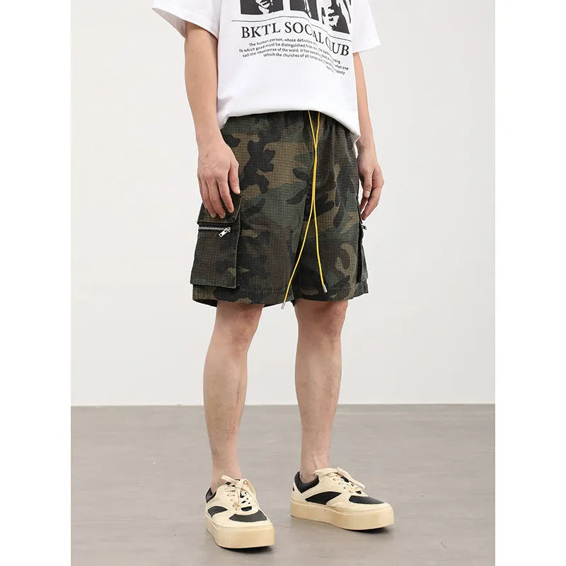 Men's camouflage pattern work shorts with multiple pockets, cropped length, and mid waist design