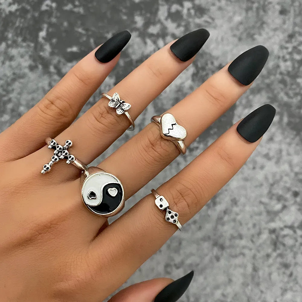 Alloy ring set with butterfly and snake retro geometric designs on display