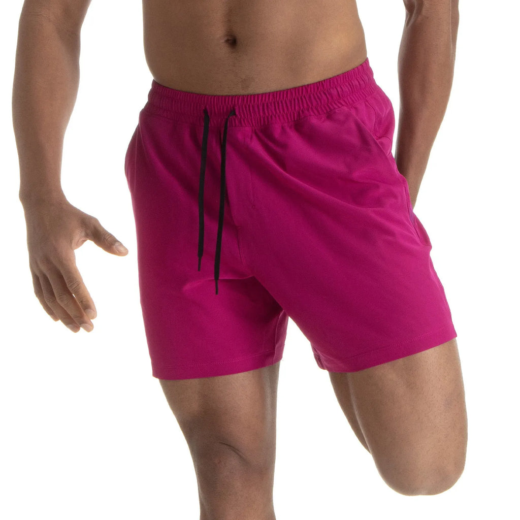 Men's black quick-drying sports shorts with mesh stitching detail on a grey background.